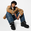 Model standing wearing LV Timberland ankle boots with streetwear outfit